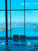 Infinity Swimming Pool mit Blick auf die Berge und den Vierwaldstättersee an einem sonnigen Tag in Burgenstock, Nidwalden, Schweiz.