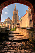 An arch leads to a church in Bruges, Belgium