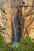 Suspension bridge and waterfall of the Caminito del Rey via ferrata near El Chorro, Andalusia, Spain