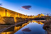 Roman Bridge over the Río Guadalquivir River and the Mezquita - Catedral de Córdoba at dusk, Cordoba, Andalusia, Spain