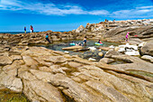 Natural pool between the rocks of the pink granite coast Côte de Granit Rose on the Ile Grande island, Pleumeur-Bodou, Brittany, France
