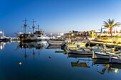 Fishing boats and tour boats in Agia Napa harbor at dusk, Cyprus, Europe