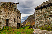 Old ruined huts on a mountain pasture. Lys Valley, Aosta Valley, Italy