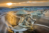 Diamond ice chards from calving icebergs on black sand beach at Jokulsarlon in south Iceland