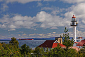 Frachter nach Kanada, vorbei am Whitefish Point Lighthouse, dem ältesten Betriebslicht am Lake Superior, Upper Peninsula, Michigan