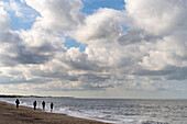 People walking on the beach of Groede in the province of Zeeland in the Netherlands.