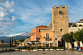 Piazza IX Aprile square, Torre dell'Orologio tower and Mount Etna, Taormina, Sicily, Italy, Europe