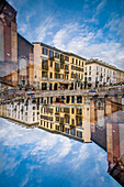 Double exposure of the buildings siding the Naviglio Grande canal in Milan, Italy.