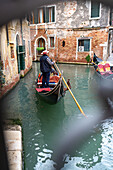 Venice - water alley with gondola, bridge and railing
