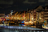 View of the harbor of Nyhavn in Copenhagen in the evening in Advent, historic sailing ships, Denmark