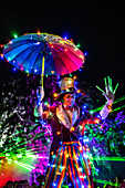 Illuminated stilt walkers at a festival of lights