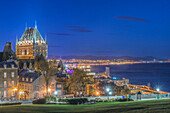 Chateau Frontenac, lit up at night in Quebec City, view over the St Lawrence river.