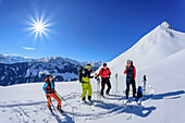 Four people on a ski tour taking a break, Kellerjoch, Zillertal, Hochfügen, Tux Alps, Tyrol, Austria