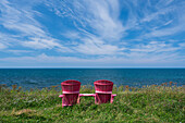 Canada, Labrador, Newfoundland, Coastal Trail, Two pink adirondack chair on coastal trail in Gros Morne National Park