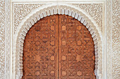Spain, Granada, Ornate wooden door and walls of the Alhambra