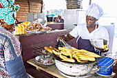 Street food stall selling grilled plantains in Ayinam in the Eastern Region of eastern Ghana in West Africa