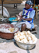 Woman preparing kenkey, soured corn balls in banana leaves in Teshie-Nungua in the Greater Accra region of eastern Ghana in West Africa