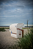 Beach grass (Ammophila arenaria) and white beach chairs, Wadden Sea, Schillig, Wangerland, East Frisia, Lower Saxony, North Sea, Germany