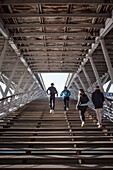 Athletes sprint up the &quot;Pont des Arts&quot; bridge, capital Paris, Ile-de-France, France