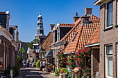 Picturesque pedestrian street and church Grote Kerk, Hindeloopen, Friesland, Netherlands, Europe