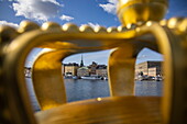 Golden crown on Skeppsholmen bridge with Gamla Stan old town behind, Stockholm, Sweden, Europe