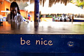 &#39;Be nice&#39; lettering on bar counter at Laluna Resort, Morne Rouge, Saint George, Grenada, Caribbean