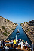 Bow of expedition cruise ship World Explorer (Nicko Cruises) behind a tugboat during passage of the Corinth Canal, near Corinth, Peloponnese, Greece, Europe