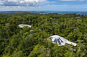 Aerial view of buildings in Veragua Rainforest Park with Caribbean Sea in distance, Limon, Limon, Costa Rica, Central America