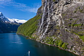 Aerial view of Zodiac inflatable boat excursion from expedition cruise ship World Voyager (nicko cruises) in front of Seven Sisters waterfall in Geirangerfjord, Geiranger, Møre og Romsdal, Norway, Europe