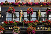 Exterior view of the Theater Royal Bar and Restaurant with decorative statues and magnificent flower baskets, Edinburgh, Scotland, United Kingdom, Europe