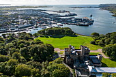 Aerial view of Lews Castle with city and expedition cruise ship World Voyager (nicko cruises) at the pier, Stornoway, Lewis and Harris, Outer Hebrides, Scotland, United Kingdom, Europe