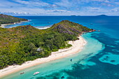 Aerial view of Anse St. Jose beach with sailing boats in Baie Laraie bay in the distance, Curieuse island, Seychelles, Indian Ocean
