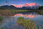 Alpenglow in the Karwendel with a view over the Schmalensee near Mittenwald, Bavaria, Germany.