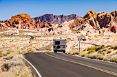 A mobile home drives through the magnificent landscape of Valley of Fire State Park in Nevada, USA
