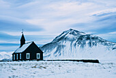 The Church of Budir on a stormy winter evening, Iceland.