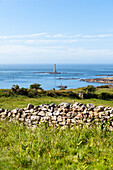 Stone wall around Goury lighthouse in spring
