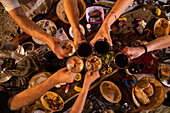 Freunde stoßen mit Weingläsern im Restaurant Argens la Guingette an, Argens-Minervois, Aude, Frankreich, Europa