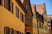 Reflected yellow light saturates the yellow color on buildings in the old town, Dinkelsbuehl, Franconia, Bavaria, Germany, Europe