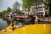 Houseboats and buildings seen from the canal boat, Amsterdam, North Holland, The Netherlands, Europe