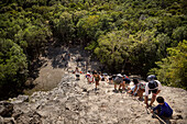 Visitors climbing the ruins of the Nohoch Mul pyramid in the Mayan ruined city of Cobá, Yucatán, Mexico, North America, Latin America
