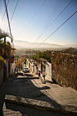 Alleyways in the city of Oaxaca de Juárez with a view of the mountainous countryside, Oaxaca State, Mexico, North America, Latin America