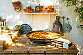 Paella Valenciana, cooked at home in the garden, home made , Costa Blanca, Spain