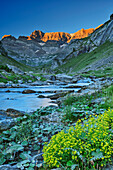 Alpenglow on the peaks of the Cirque d'Estaube with a stream in the foreground, Gavarnie, Pyrenees National Park, UNESCO World Heritage Site Monte Perdido, Pyrenees, France