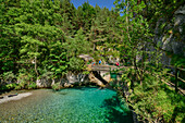 Hikers walk on bridge over Rio Arazas, Ordesa Valley, Ordesa y Monte Perdido National Park, Ordesa, Huesca, Aragon, Monte Perdido UNESCO World Heritage Site, Pyrenees, Spain