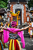 A young woman in traditional dress dancing for the festival Gulangan in Karangasem Bali Indonesia