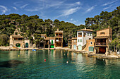 Fishermen's houses with boat garages, shore with sunbathers, Cala Figuera, Santanyí, Mallorca, Spain