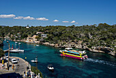 Entry of the excursion boat Catamaran Starfish into the port of Cala Figuera, Santanyí, Mallorca, Spain