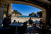 Blick von einem Strandrestaurant zum Strand und den Badegästen, Bucht Cala Santanyí, Mallorca, Spanien