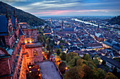 View of the north facade of Heidelberg Castle ruins as well as the old town and Neckar (river) during blue hour, Heidelberg, Baden-Wuerttemberg, Germany, Europe