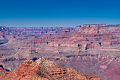 The Grand Canyon as seen from the South Rim in Arizona. The large gorge was eroded over millions of years by weather and the Colorado river that still runs through it. The reddish tint it has is due to the iron contained in the rock's minerals that oxide.